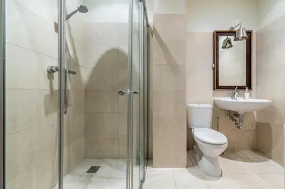 a bathroom with a shower and a toilet and a sink at City center, free parking, 4A in Vilnius