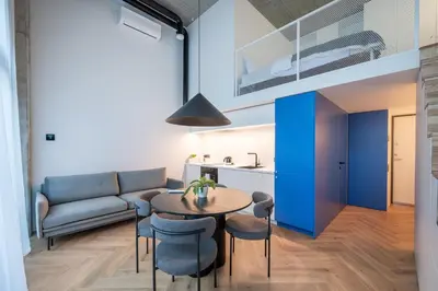 a living room with a table and a couch at Paupys Central Lofts by Reside Baltic in Vilnius