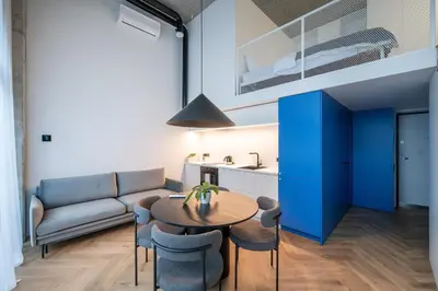 a living room with a table and a couch at Paupys Central Lofts by Reside Baltic in Vilnius