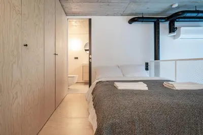 a bedroom with a bed with towels on it at Paupys Central Lofts by Reside Baltic in Vilnius