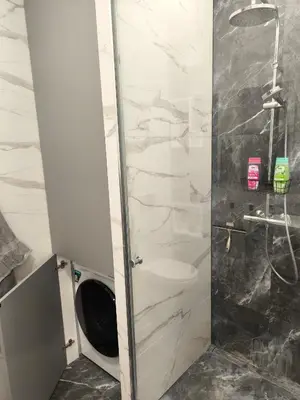 a bathroom with a shower with a toilet at Jaukus butas Šiaulių centre in Šiauliai