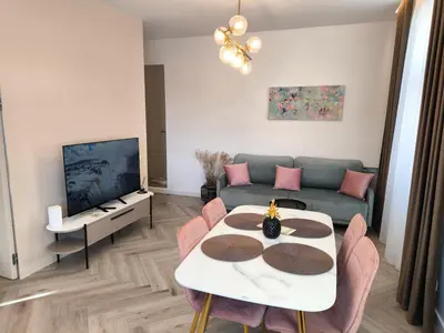 a living room with a couch and a table at Jaukus butas Šiaulių centre in Šiauliai