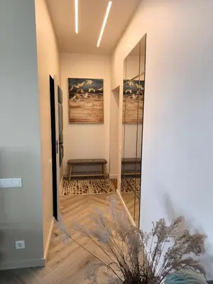 a hallway with a door leading into a room at Jaukus butas Šiaulių centre in Šiauliai