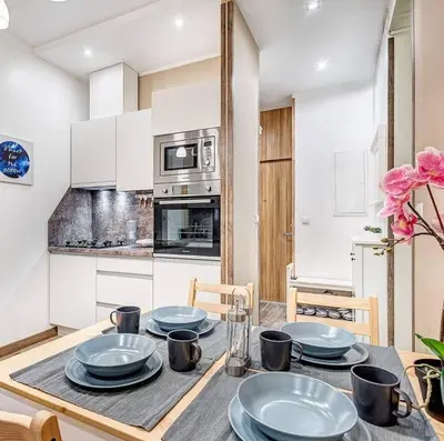 a kitchen with a table with blue plates on it at Sauna 5 bedrooms apartment in old town & Parking in Kaunas