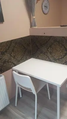 a white desk with a chair and a clock at Sauna 5 bedrooms apartment in old town & Parking in Kaunas