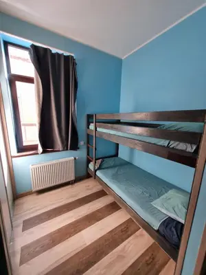 two bunk beds in a room with a window at Sauna 5 bedrooms apartment in old town & Parking in Kaunas