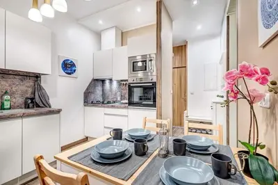 a kitchen and dining room with a table and chairs at Sauna 5 bedrooms apartment in old town & Parking in Kaunas