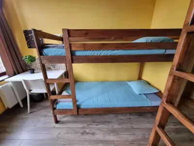 two bunk beds in a room with a table at Sauna 5 bedrooms apartment in old town & Parking in Kaunas