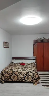 a bedroom with a bed and a dresser at Honey Apartament in Druskininkai