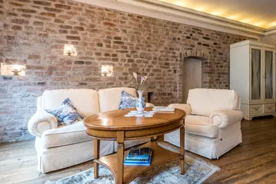 a living room with a couch and a table at Castle Street Retreat, 19 in Vilnius