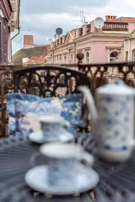 a group of cups and saucers sitting on a table at Castle Street Retreat, 19 in Vilnius