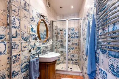 a blue and white bathroom with a sink and shower at Castle Street Retreat, 19 in Vilnius