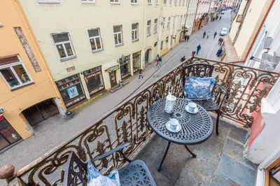 an empty balcony with a table and chairs on a street at Castle Street Retreat, 19 in Vilnius