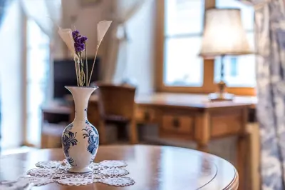 a vase sitting on a table with flowers in it at Castle Street Retreat, 19 in Vilnius