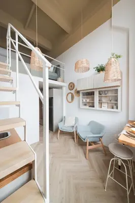 a living room with a loft bed and a table at Cozy & Stylish Loft near the city center in Vilnius