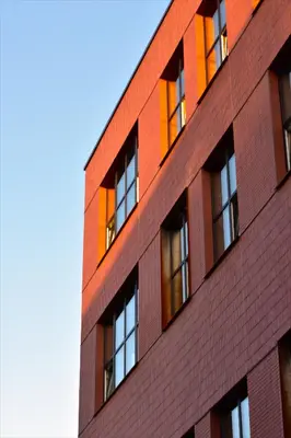 a brick building with windows on the side of it at Cozy & Stylish Loft near the city center in Vilnius