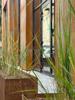 a door to a building with plants in front of it at Cozy & Stylish Loft near the city center in Vilnius