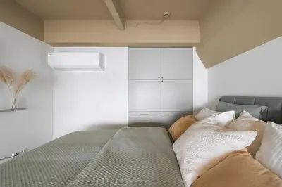 a bedroom with a bed with pillows on it at Cozy & Stylish Loft near the city center in Vilnius