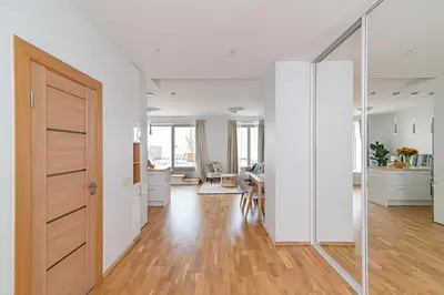 an open hallway with a door and a living room at Bright 1 BDR apartment in Vivid Paupys by URBAN RENT in Vilnius