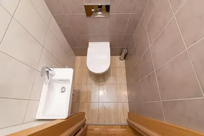a small bathroom with a toilet in the corner at Bright 1 BDR apartment in Vivid Paupys by URBAN RENT in Vilnius
