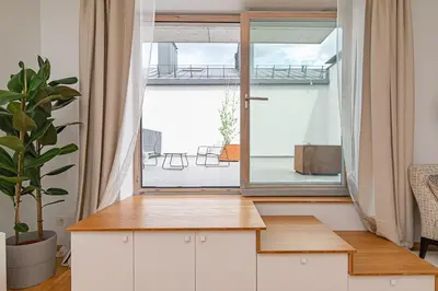 a room with a large window and a table at Bright 1 BDR apartment in Vivid Paupys by URBAN RENT in Vilnius