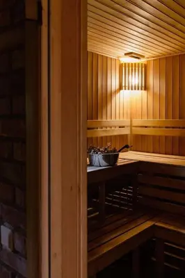 a sauna with a table with bowls on it at Gilužio sodyba in Girsteitiškis