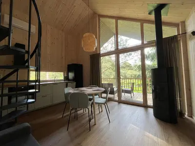a kitchen and dining room with a table and chairs at Gilužio sodyba in Girsteitiškis