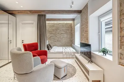 a living room with a red chair and a couch at Vilnius city, 17 FREE Street Parking in Vilnius