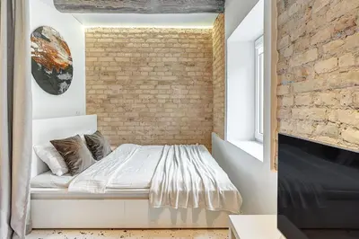 a bedroom with a brick wall and a bed at Vilnius city, 17 FREE Street Parking in Vilnius