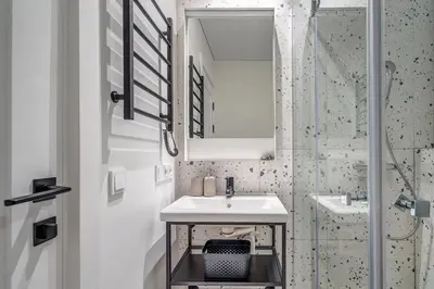 a white bathroom with a sink and a shower at Vilnius city, 17 FREE Street Parking in Vilnius