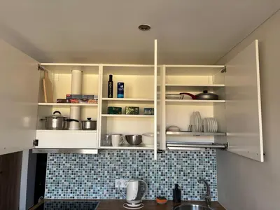 a kitchen with white cabinets with pots and pans at Maslow apartments - Self check in in VNO