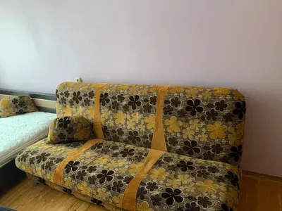a couch sitting in the corner of a room at Minties apartment in Vilnius