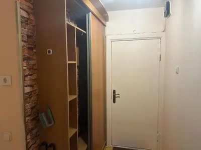 a white door in a room with a brick wall at Minties apartment in Vilnius