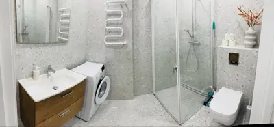 a bathroom with a shower and a toilet and a sink at STAR apartamentai in Panevėžys