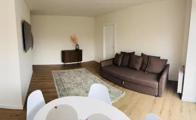 a living room with a couch and a table at STAR apartamentai in Panevėžys