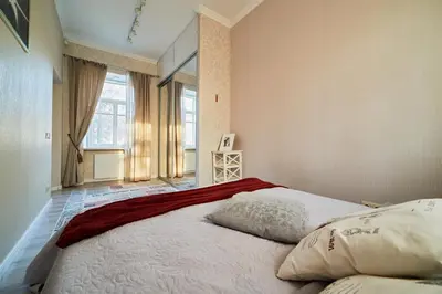 a large bed in a room with a large window at Old Town Apartment Free parking in Vilnius