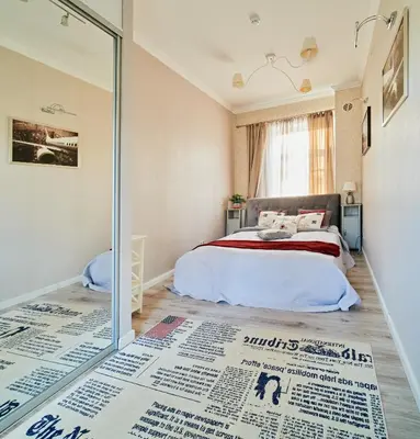 a bedroom with a bed and a glass door at Old Town Apartment Free parking in Vilnius