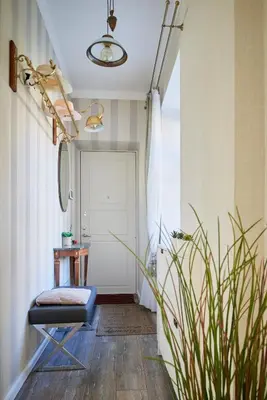 a hallway with a chair and a door at Old Town Apartment Free parking in Vilnius