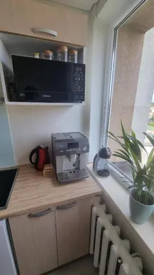 a kitchen with a printer on a counter with a window at Tiny cozy apartment 'Unihus' in Varėna