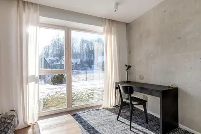 a room with a desk and a large window at Sunny, Peaceful & Spacious Apartment by URBAN RENT in Vilnius