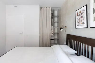 a bedroom with a large bed with white sheets at Sunny, Peaceful & Spacious Apartment by URBAN RENT in Vilnius