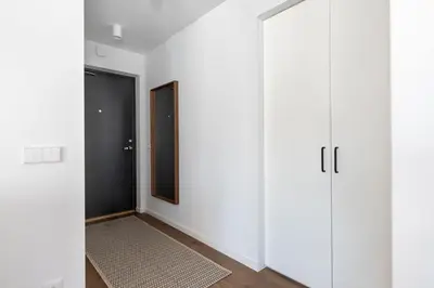 a room with white cabinets and a door at Sunny, Peaceful & Spacious Apartment by URBAN RENT in Vilnius