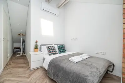 a bedroom with a bed with two towels on it at Timeless Bliss Old Town Apartment by Reside Baltic in Vilnius