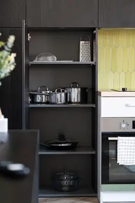 a kitchen with some pots and pans on shelves at Timeless Bliss Old Town Apartment by Reside Baltic in Vilnius