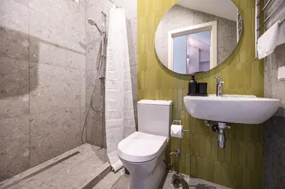 a bathroom with a sink and a toilet and a mirror at Timeless Bliss Old Town Apartment by Reside Baltic in Vilnius
