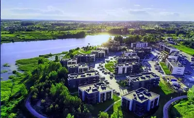 an aerial view of a building next to a river at Gilužio Apartments in Vilnius