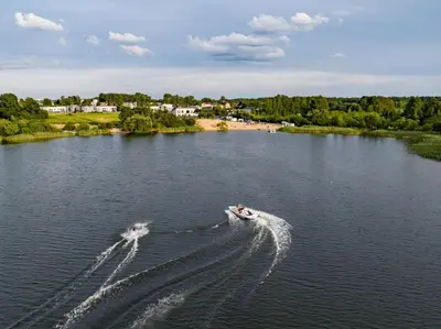 two boats are in the water on a river at Gilužio Apartments in Vilnius