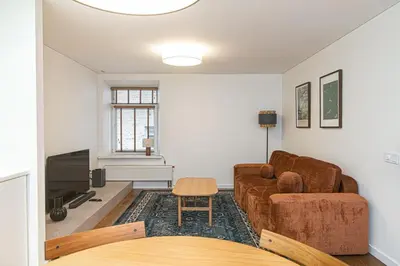 a living room with a couch and a tv at Stylish & Comfortable 1-Bedroom Apartment in Vilnius Old Town by URBAN RENT in Vilnius