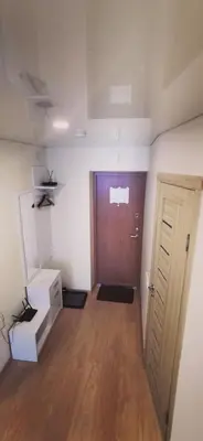 an empty room with a door and a wooden floor at Lauros 1 & R Apartamentai in Panevėžys