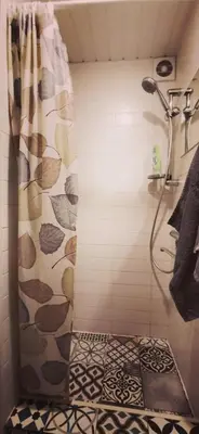 a bathroom with a shower with a shower curtain at Lauros 1 & R Apartamentai in Panevėžys